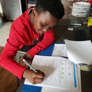 Nakoa practices math at home.