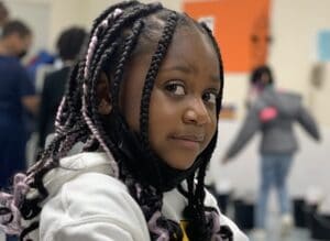 Girl looking serious at work - UNESCO International Literacy Day