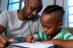 Father and son work on math.