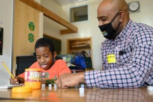 Tutor and child platy a math game.