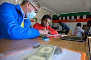 Devonte and Mr. Carl counting money.