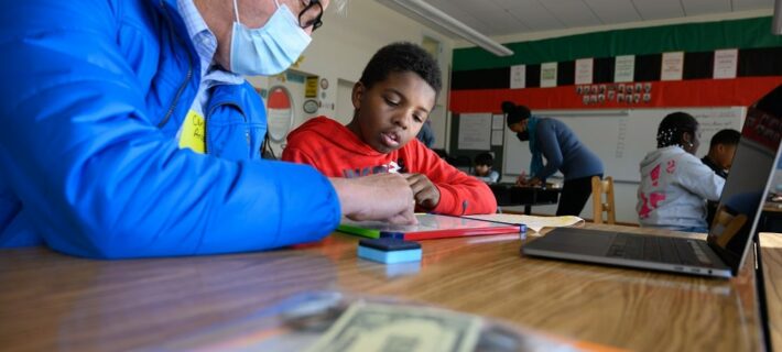 Devonte and Mr. Carl counting money.