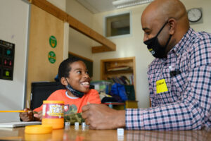 Volunteer tutor with smiling child