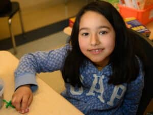 Girl smiling at tutoring session.