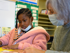 Vilma Morales tutors a student.