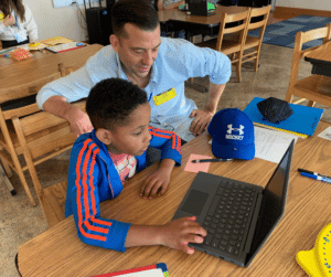 Samuel and Eric (volunteer tutoring) work on math together.